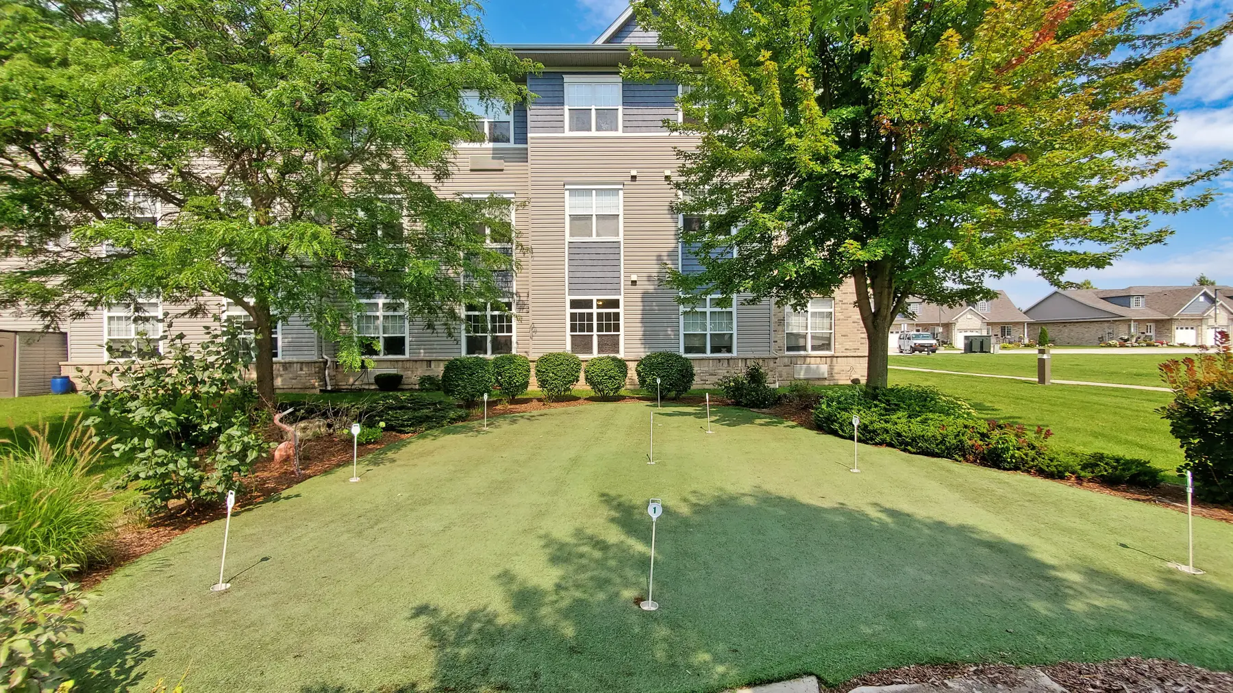 Golf area with exterior of building at Chartwell Royal Oak Village