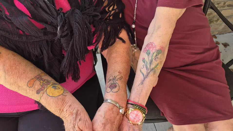 Close-up of Shirley’s forearm tattoos at Chartwell Oak Park Terrace