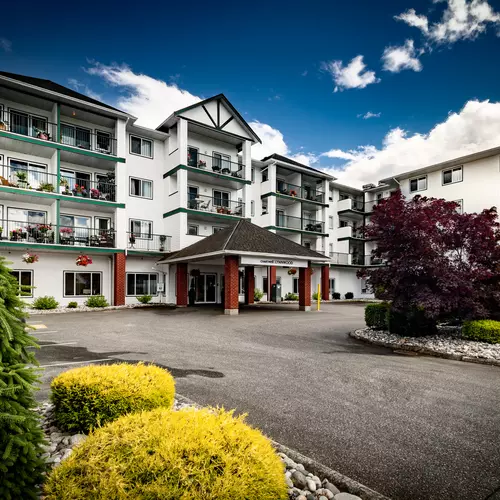 wide angle exterior picture of the front of the building and entrance at chartwell lynnwood house retirement residence