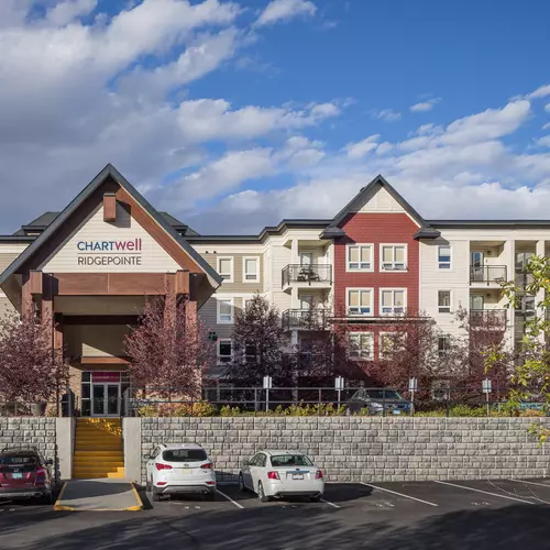 exterior front entrance and parking lot at chartwell ridgepointe retirement residence